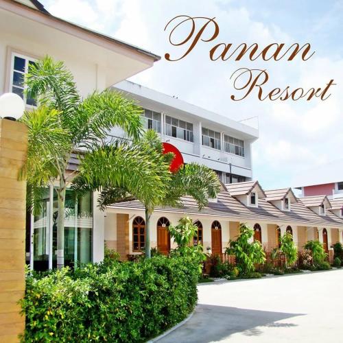 a resort with palm trees in front of a building at โรงแรม ปาหนัน รีสอร์ท - Panan Resort in Prachuap Khiri Khan