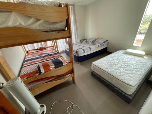 a room with two bunk beds and a small bed at El Sol de Simbal in Trujillo