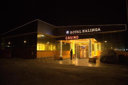 a person standing outside of a building at night at Gautam Buddha International Hotel Ltd in Gautam Buddha International Airport