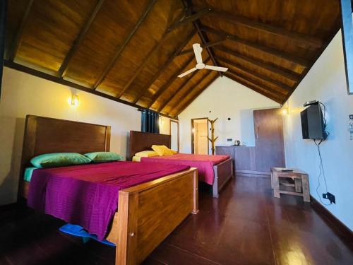 a bedroom with two beds and a tv in it at Hasruk Eco Rest in Yatipauwa