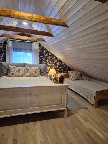 a bedroom with a large bed and a window at Vintage Four katusekorter in Haapsalu