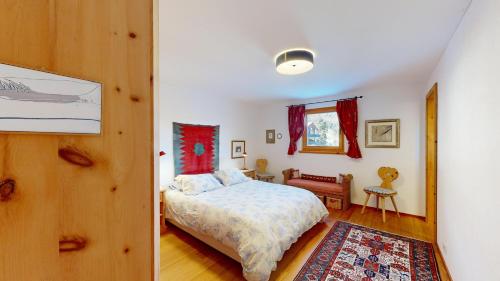 a bedroom with a bed in a room at Apartment Macun in Silvaplana