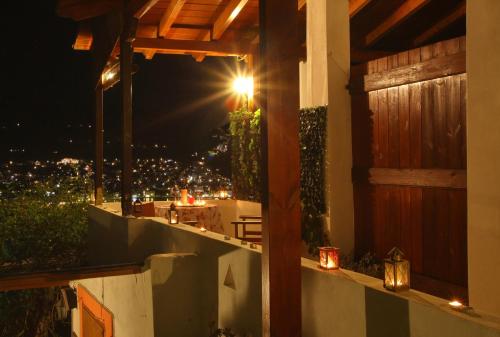 a balcony with a view of a city at night at Irene' s Paradise in Skopelos Town