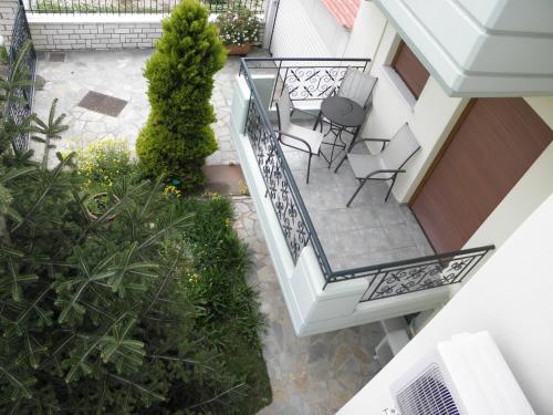 an overhead view of a balcony with chairs and plants at Tsironis Guesthouse in Ioannina