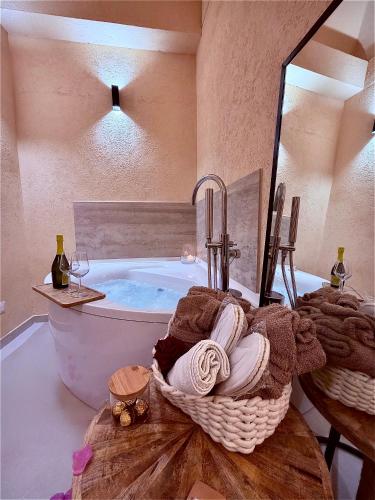 a bathroom with a tub and a sink with towels at Bìfara Rooms in Palermo