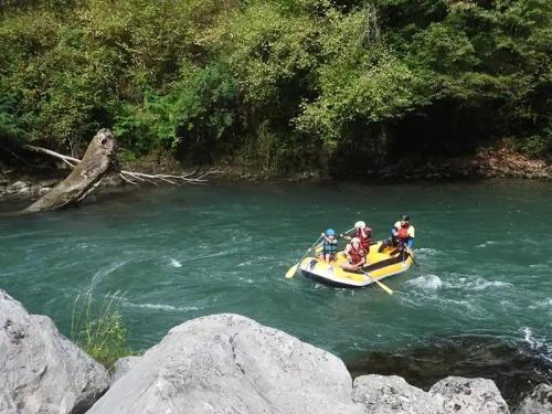 a group of people on a raft in a river at ZEcamping 3 étoiles piscine animaux acceptés in Montaut