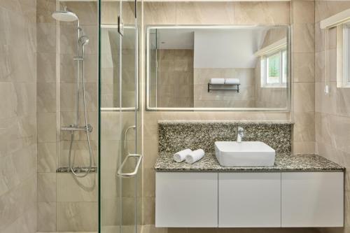 a bathroom with a sink and a shower at LIME Resort Bohol, a member of Radisson Individuals Premier in Panglao Island