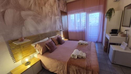 a bedroom with a large bed with towels on it at CinqueStanze in Cosenza