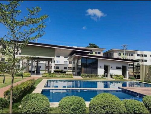 an exterior view of a house with a swimming pool at Cozy Plumera Studio near Mactan Airport in Bankal