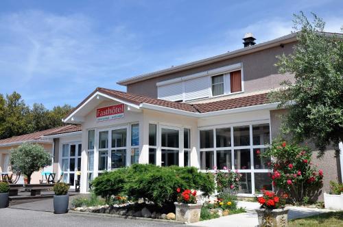 un bâtiment hospitalier avec des fleurs devant lui dans l'établissement Fasthotel Toulouse Blagnac Aéroport, à Blagnac