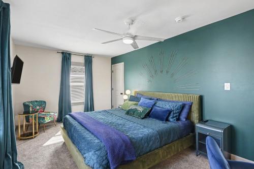a bedroom with a bed and a blue wall at Cozy 2BR Near Ohio State - Private Yard - Parking in Columbus