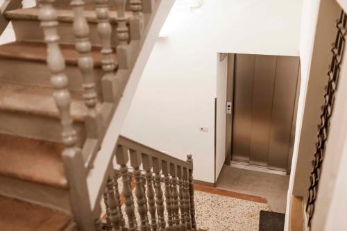 a stairway leading up to a door in a building at Stay COOPER l Laubenhaus in Bolzano