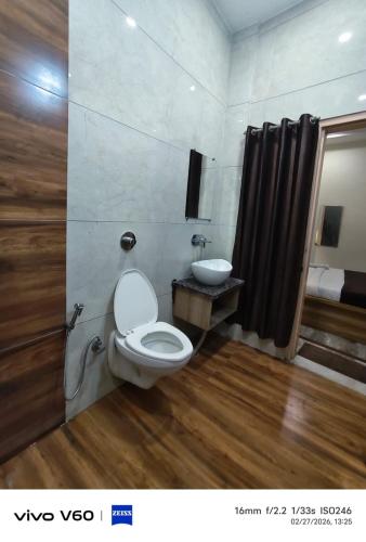 a bathroom with a toilet and a sink at HR King HOTEL in Amritsar