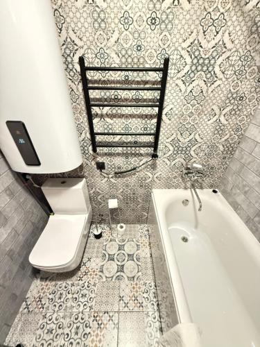 a bathroom with a toilet and a bath tub at Villa Victoria in Ventspils
