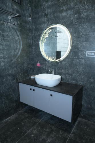 a bathroom with a sink and a mirror at Shree Shankar Paradise in Pharod