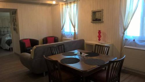 a living room with a table and a couch at Gîte Bien-Etre in Walscheid