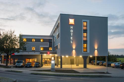 a rendering of the front of a hotel at Ibis München Airport Süd in Hallbergmoos