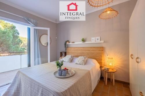 a bedroom with a bed with a table on it at El Secret de la Fosca in Palamós