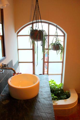 a bathroom with an orange tub on a counter with a window at Quinua Boutique Apartments in Cusco