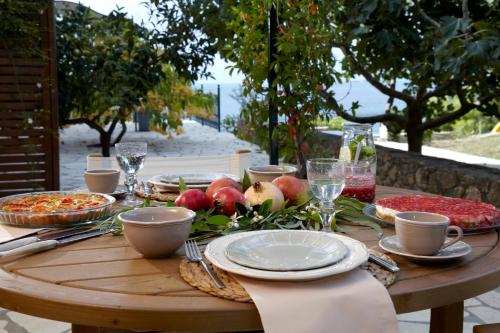 a wooden table with food and fruit on it at Avra Private Suites in Lassi