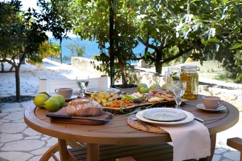 a wooden table with food on top of it at Avra Private Suites in Lassi