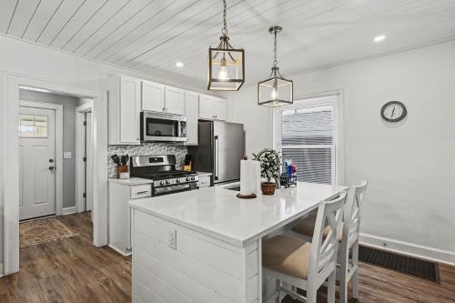 a kitchen with white cabinets and a white counter top at Cozy Campbell Bungalow in Columbus