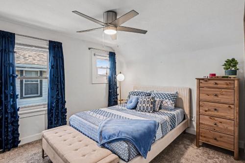 a bedroom with a bed and a ceiling fan at Luxe 2BR Franklinton - Private Patio - 2Car Garage in Columbus