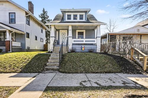 a home with a white house with a driveway at Luxe 2BR Franklinton - Private Patio - 2Car Garage in Columbus