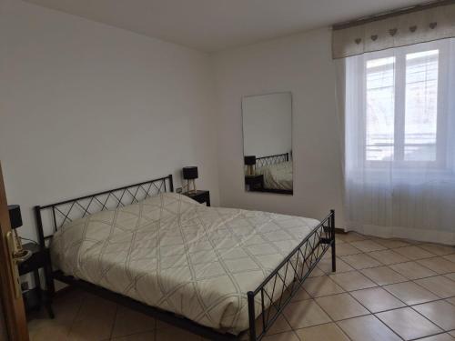 a white bedroom with a bed and a window at Ali Gio in Alzano Lombardo