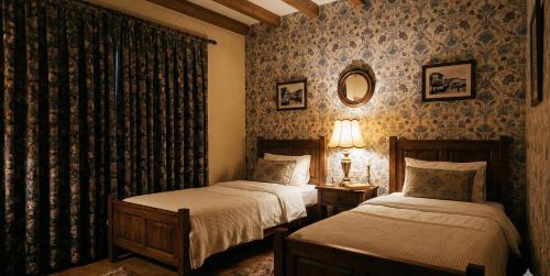 a bedroom with two beds and a mirror at Zefir Apart in Ordu