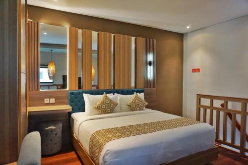 a bedroom with a large bed and a fireplace at The New Moon Umalas in Seminyak