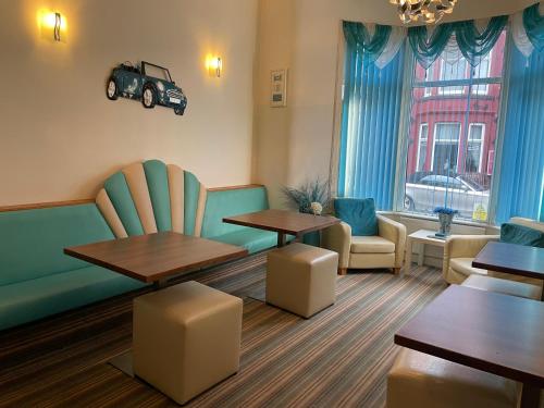 Ein Wartezimmer mit Tischen und einem Auto an der Wand in der Unterkunft Beeches Hotel in Blackpool