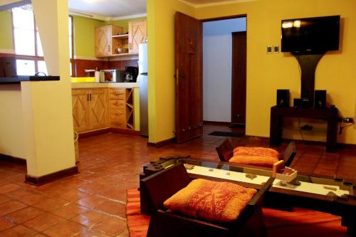 a living room with a couch and a table at Quinua Boutique Apartments in Cusco