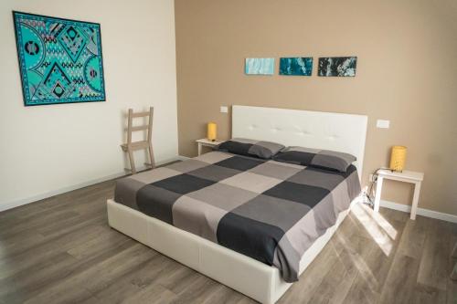 a bedroom with a bed with a black and white comforter at Casa Mirella in Cavallino-Treporti