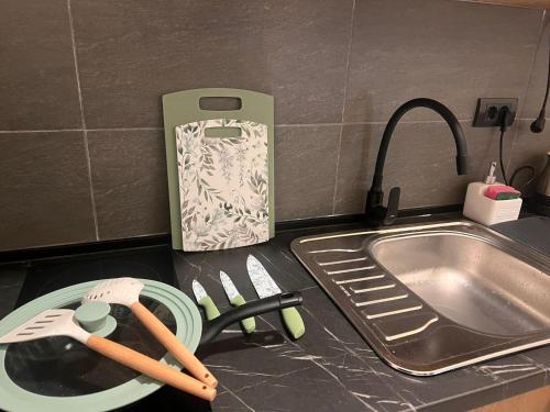 a kitchen counter with a knife block next to a sink at Misho Hills Retreat in Kopaonik