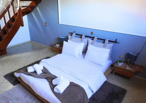a bedroom with a large bed with towels on it at Dimitra's Villa in Evia, Greece in Loukísia