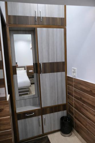 a bedroom with a mirror and a bed in a room at The Asanar Hills in Rūpnagar