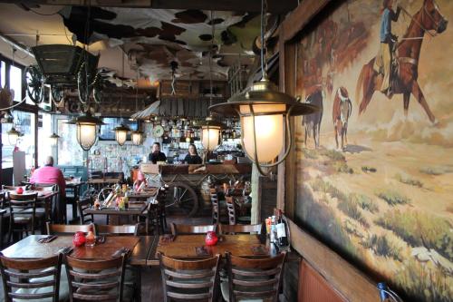 a restaurant with a large painting of animals on the wall at Hotel Restaurant Old Bridge in Amsterdam