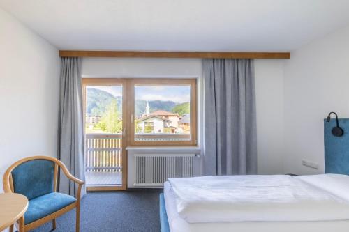 a hotel room with a bed and a window at Rössle Appartement in Bezau