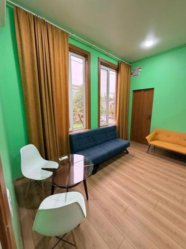 a living room with a couch and a table and chairs at Green Home in Kobuleti