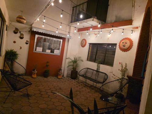 a living room with chairs and lights on the ceiling at Casa Lú in Oaxaca City