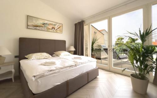 a bedroom with a large bed and a large window at Villa Damiani " Partys and loud music forbidden!!!" in Pula