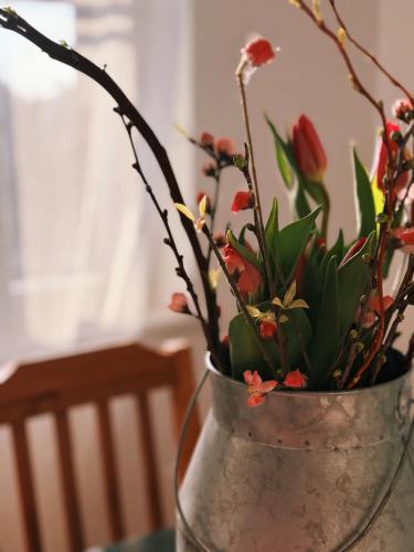 a vase with flowers in it on a table at Venkovský Útulek in Lázně Libverda