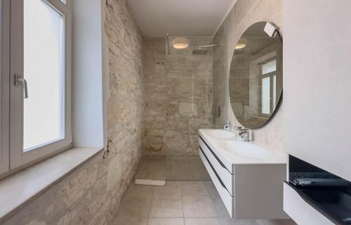 a bathroom with a sink and a mirror at Villa Damiani " Partys and loud music forbidden!!!" in Pula