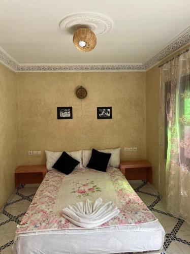 a bedroom with a bed with two towels on it at Riad Mahjouba Marrakech & SPA in Marrakesh