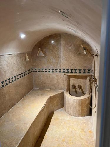 a bathroom with a tub with two faucets at Riad Mahjouba Marrakech & SPA in Marrakesh