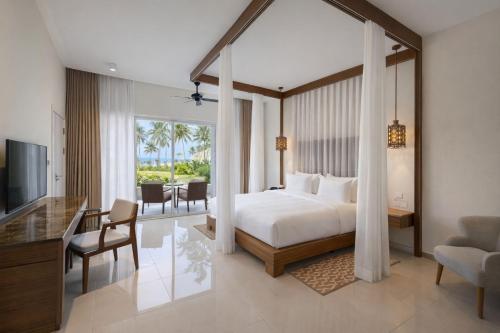 a bedroom with a bed and a living room at Diamonds Bijoux in Bwejuu