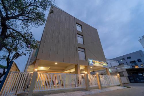 a building with a wooden fence in front of it at Treebo Premium Cachet Suites in Coimbatore