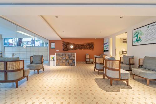 a waiting room at a hospital with chairs and a fireplace at Treebo Premium Cachet Suites in Coimbatore