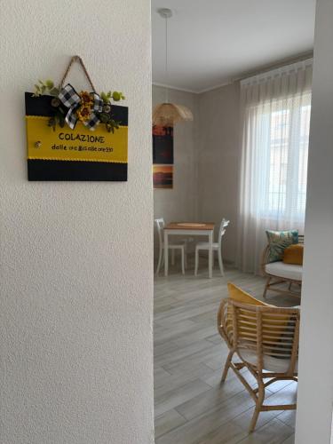 a living room with a sign on the wall at B&B Le Saline Bed & Breakfast in Cervia